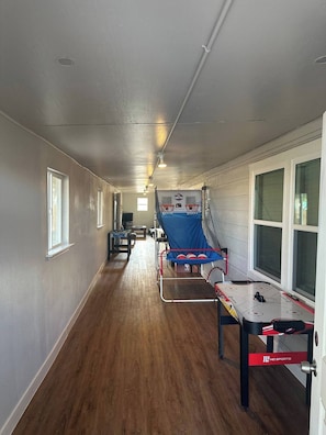 The indoor Gameroom features various games like a Ice hockey and basketball.