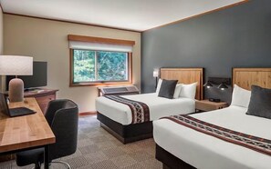 A serene bedroom with inviting beds and a calming view, creating a restful escape.