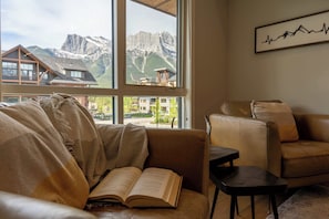 Cozy up in the comfortable living room chairs and enjoy a morning coffee with a book from our selection provided in the living room credenza