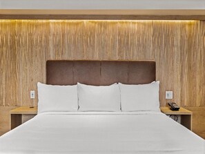 A serene bedroom with warm lighting and a plush bed, offering a restful and inviting atmosphere for a perfect night's sleep.