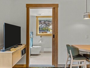 A cozy corner with a small dining table and a TV, perfect for enjoying meals or unwinding with your favorite shows after a day of adventure.