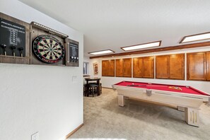 Downstairs game room with pool table and darts