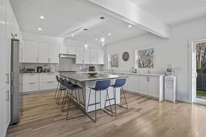 Modern kitchen with sleek countertops, plenty of storage, and all essential appliances