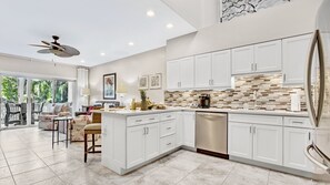 The kitchen has a modern feel and neutral tones...