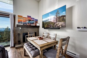 Dining area with a cozy fireplace, ideal for shared meals and game nights.