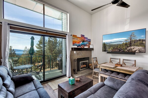 Cozy living room with plush seating, a fireplace, and breathtaking views.