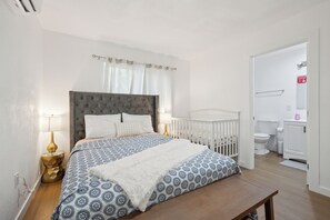 Sweet dreams in this cozy bedroom, featuring a baby crib for peace of mind.