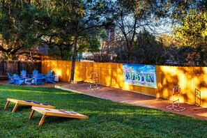 The fully fenced backyard has many fun spaces and amenities.
