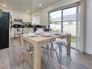 Bright and spacious dining area with an table that accommodates 6 guests.