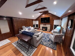 72" 4K compatible TV with Roku Guest Mode setup. Woodburning fireplace as well.