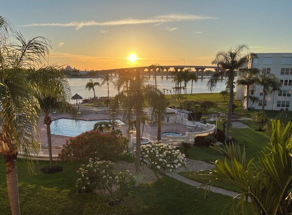 View of the pool and bay from our balcony at sunset