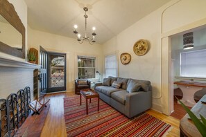 Casita #2: Living room area with pull-out sofa and view of kitchen's dining nook
