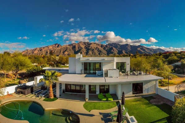 MH: View of the back of the property with its spacious backyard