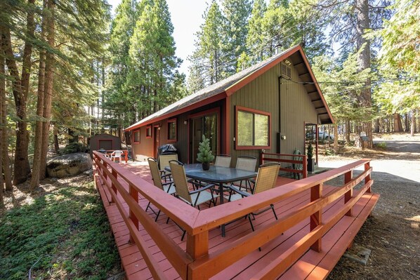 Exterior view of deck with table, 6 chairs and propane BBQ
