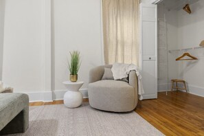 Calming decor and a comfy seating area await you in the main bedroom!