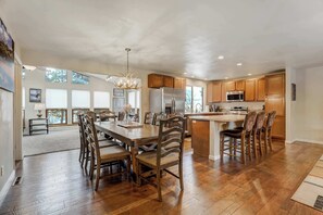 Gather in the open-concept living space with cozy seating, a large Smart TV, and a spacious dining area perfect for entertaining!