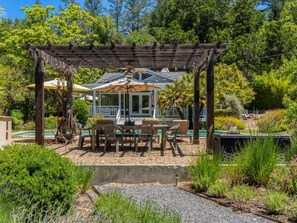 Dine al fresco at the poolside outdoor dining area, sits 6 under a pergola!
