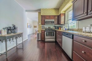 "Prepare delicious meals in this fully equipped kitchen. With modern appliances and ample counter space, it has everything you need to create culinary masterpieces."

