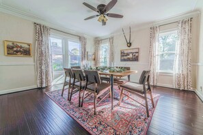 "Gather around the table in this charming dining room, perfect for sharing meals and creating memories with loved ones. The warm and inviting atmosphere sets the stage for unforgettable dining experiences."

