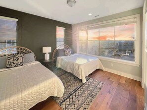 Bedroom 2: Modern twin room with a bold feature wall and comfortable beds to ensure restful nights.