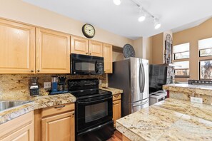 Full kitchen with breakfast bar.