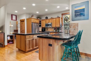 The warm, open kitchen offers ample space & every home comfort