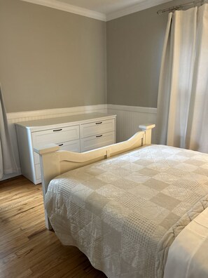 Alternate view of downstairs bedroom. Includes dresser, closet and hangers