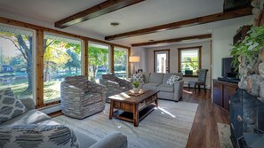 Living room with floor to ceiling windows offer stunning view of the river.
