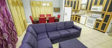 Only beauty, no beast in this comfortable open living room. The couch seats 6 comfortably, and can easily be turned into a cozy movie watching spot with the ottoman.