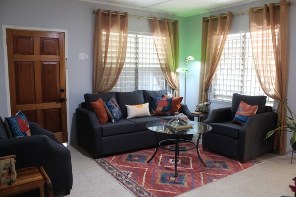 Spacious and comfortable living room with a touch of Caribbean charm.
