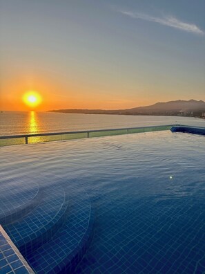 Rooftop infinity pool at sunset
