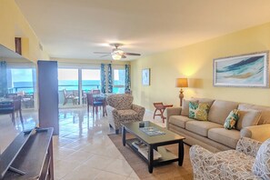 Living room offers Roku TV, ocean views, a sleeper sofa, and balcony access. 
