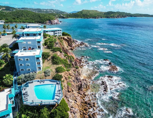 Pool chairs are accessible and offer breathtaking views of the surrounding cliff