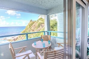 Enjoy the ocean breeze and island view from the balcony seating outside.