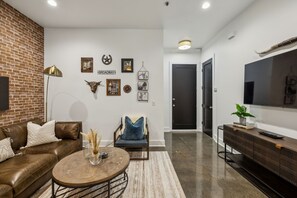 Comfortable living room seating with gallery wall and Smart TV