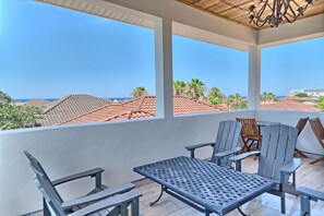 Relax on the breezy balcony with panoramic views of the rooftops and the sparkling Gulf in the distance