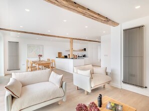 Open-space living area with comfy sofa and chairs