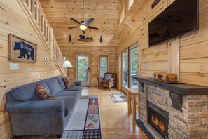 Living room with fireplace and vaulted ceilings