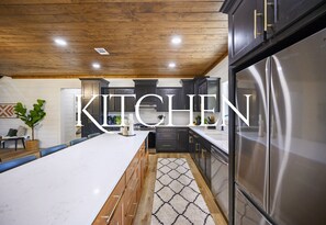 The spacious kitchen offers sleek design, high-end appliances, and plenty of counter space for cooking and entertaining.