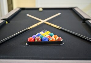 The game room’s pool table is ready for friendly competition and laughter-filled evenings with your group.