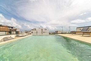 The pool area is perfect for relaxing with family or friends, featuring plenty of seating and stunning views.