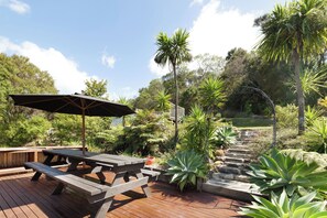 Sunny and spacious outdoor area with 12-seater table and sun umbrella