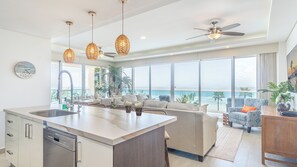 Spacious floor plan with floor to ceiling windows provides a panoramic view of the beach.