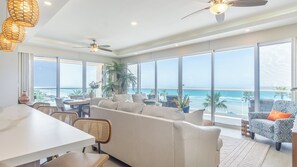 Wrap around windows highlight the beach in the this luxurious end unit.