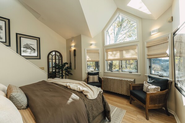 Natural light from the cathedral window floods the master suite.