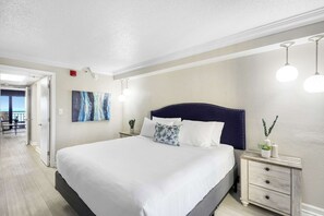 Unwind in comfort with this serene king bedroom, featuring soft lighting, coastal-inspired decor, and a plush mattress for a restful sleep. Wake up refreshed with a peek of the ocean just down the hall.