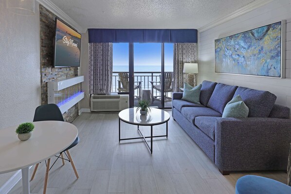 Wake up to ocean views in this stylish beachfront retreat featuring a cozy fireplace, smart TV, and private balcony. Perfect for a relaxing getaway or remote work with a view. Steps from the sand, surf, and sunshine.