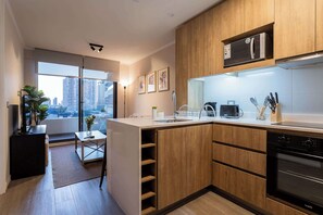 Sleek modern kitchen with city views, perfect for cooking and relaxing in style.