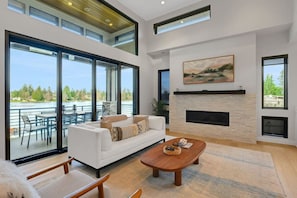 LIVING ROOM ON THE MAIN FLOOR WITH A STUNNING LAKE VIEW 🌅