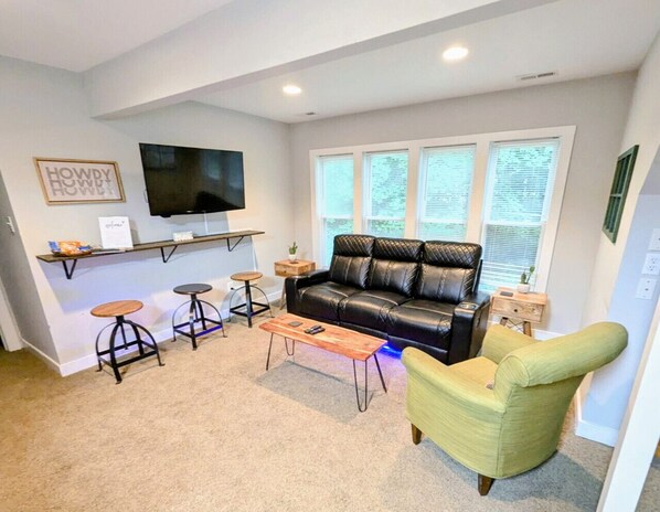 Upper level living room with ample seating and flat-screen Roku TV.
